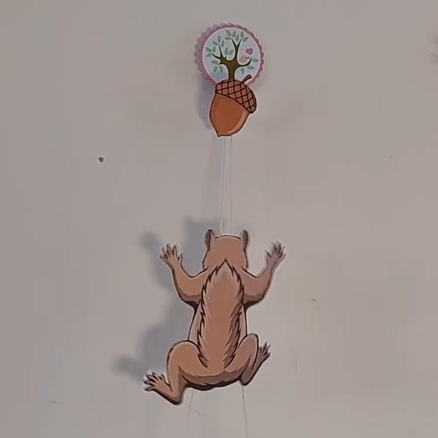 squirrel trying to reach an acorn